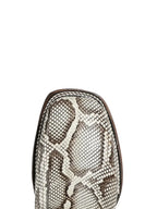 Snakeskin-patterned boot toe on a light gray background
