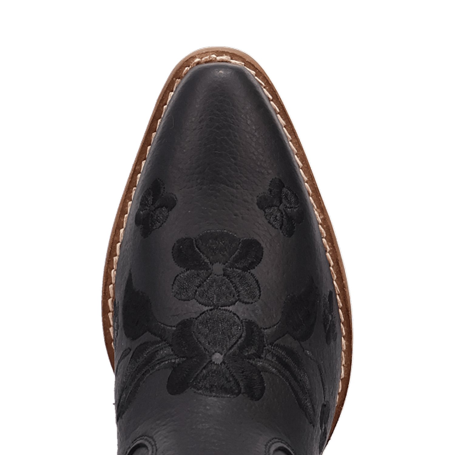 Close-up of the pointed toe of a black leather cowboy boot with floral tooling and a tan sole edge, shown on a white background.
