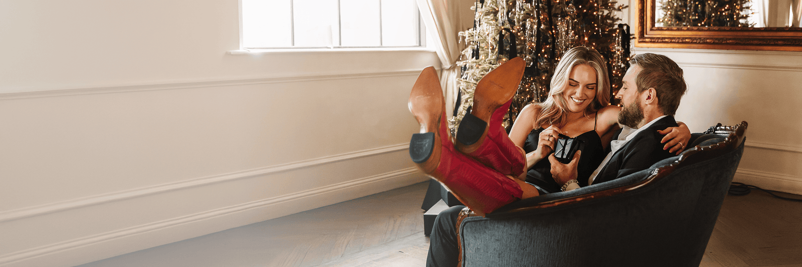 a person wearing red boots and sitting on a couch