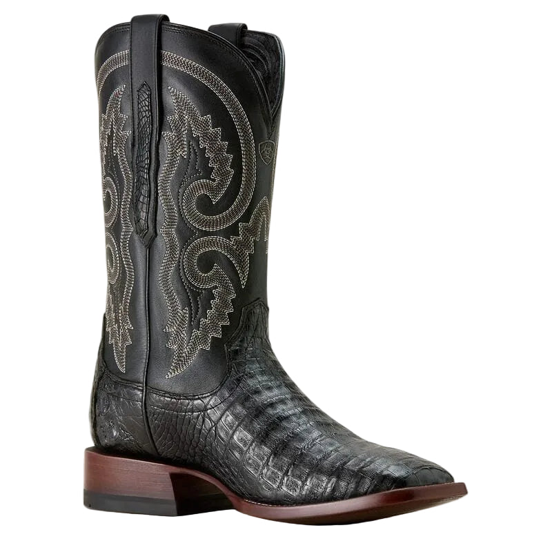 Black Caiman skin cowboy boot with intricate stich patterns on a white background. 
